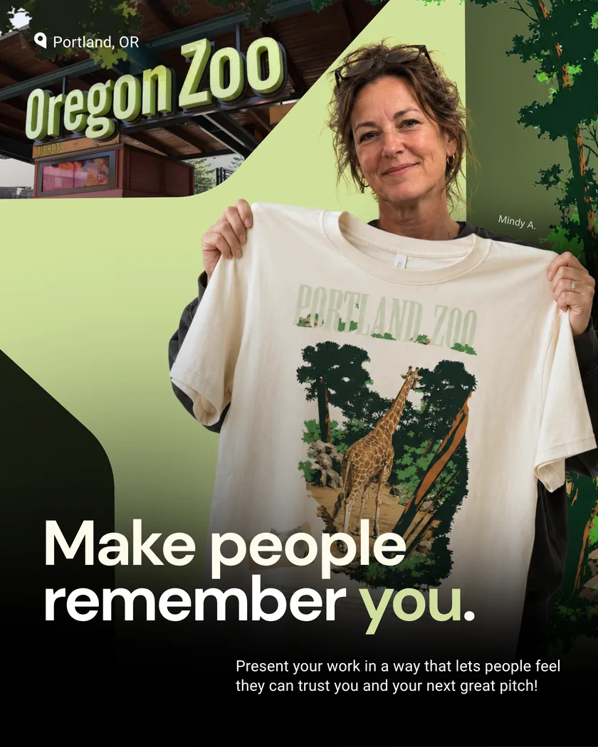 Oregon Zoo employee holding a branded T-shirt.